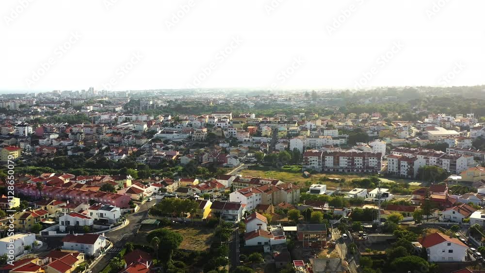 Explore the stunning aerial view showcasing a peaceful residential neighborhood in Portugal bathed in early morning light. The lush greenery and varied architecture create a serene atmosphere. Explore the stunning aerial view showcasing a peaceful residential neighborhood in Portugal bathed in early morning light. The lush greenery and varied architecture create a serene atmosphere.