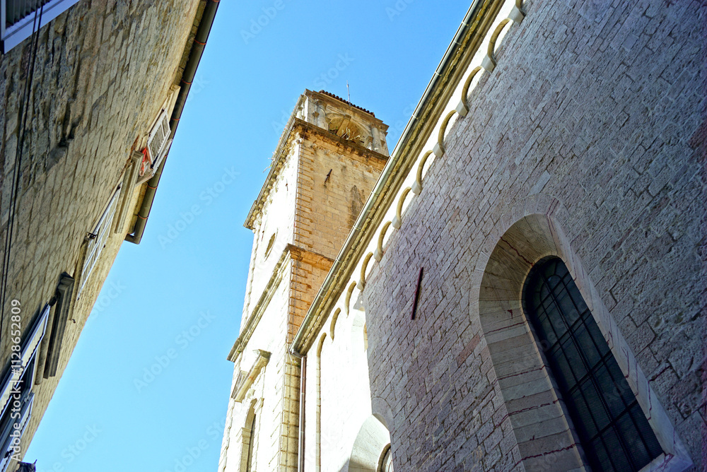 Φωτογραφία Kotor Cathedral: one of the church's bell towers and stonework on the facade of the Romanesque church