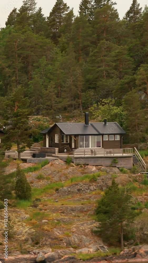 Red Scandic Wooden Houses On Island Coast In Summer Cloudy Day. Nordic Architecture. Vertical Footage Video Hyperlapse. Travel Concept To Sweden. Scandinavian Culture And Nature Red Scandic Wooden Houses On Island Coast In Summer Cloudy Day. Nordic Architecture. Vertical Footage Video Hyperlapse. Travel Concept To Sweden. Scandinavian Culture And Nature