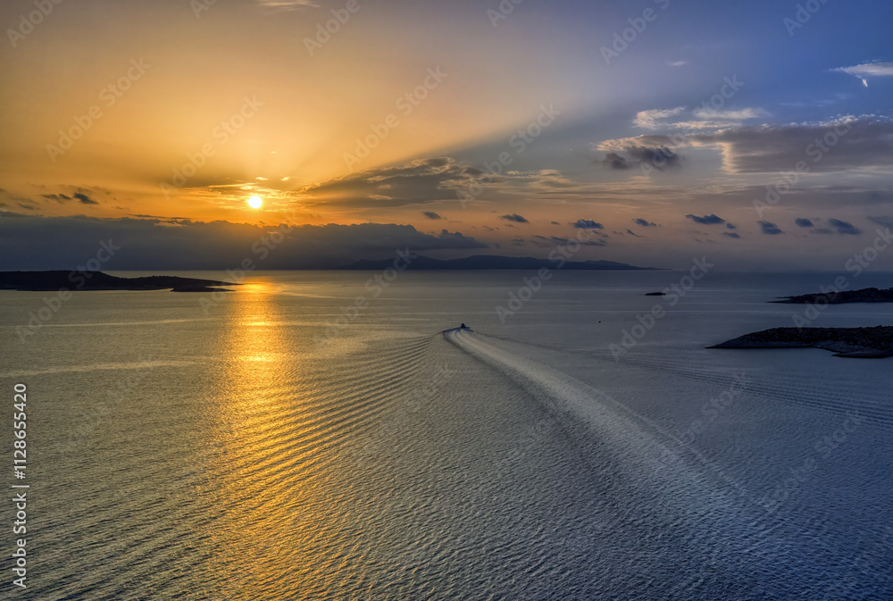 Golden Hour Serenity: A Boat Trails Through the Aegean Sunset Golden Hour Serenity: A Boat Trails Through the Aegean Sunset