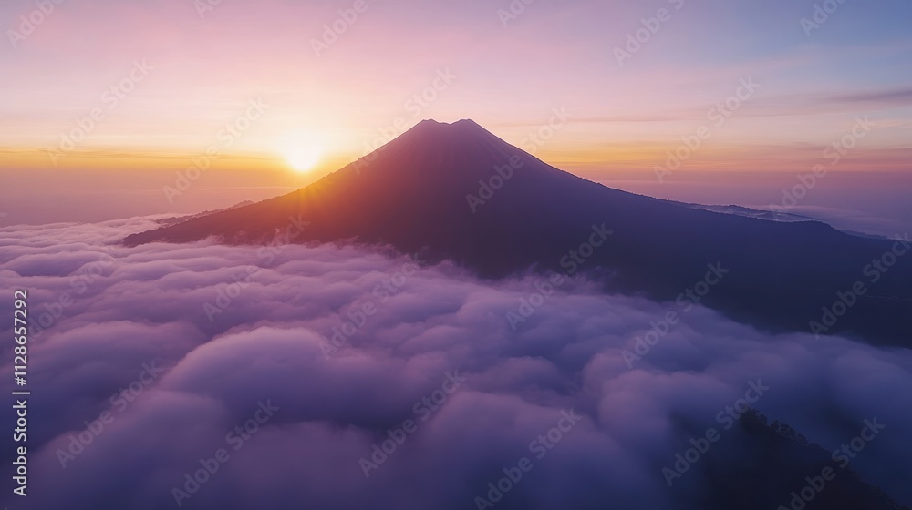 A bird's eye view of a majestic mountain peak emerging above a blanket of clouds, with the sun casting a warm glow at dawn, the sky painted in soft gradients of pink and purple A bird's eye view of a majestic mountain peak emerging above a blanket of clouds, with the sun casting a warm glow at dawn, the sky painted in soft gradients of pink and purple