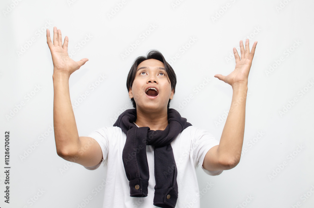 Happy and Surprised Young Asian Man in Casual Outfit Celebrating Victory Happy and Surprised Young Asian Man in Casual Outfit Celebrating Victory
