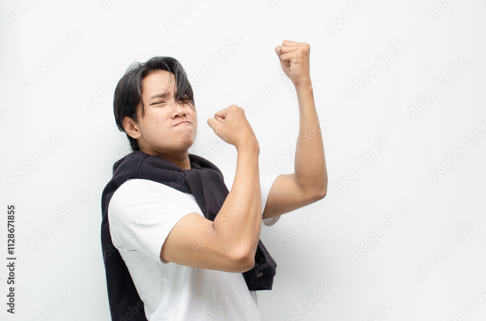 Happy and Surprised Young Asian Man in Casual Outfit Celebrating Victory Happy and Surprised Young Asian Man in Casual Outfit Celebrating Victory