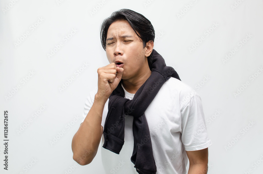 Young Asian Man Coughing and Showing Symptoms of Flu with Fever Young Asian Man Coughing and Showing Symptoms of Flu with Fever