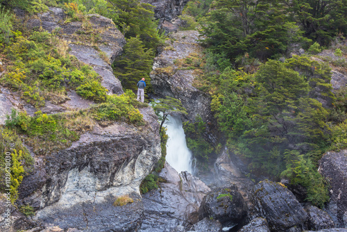 Hiker near waterfall photo