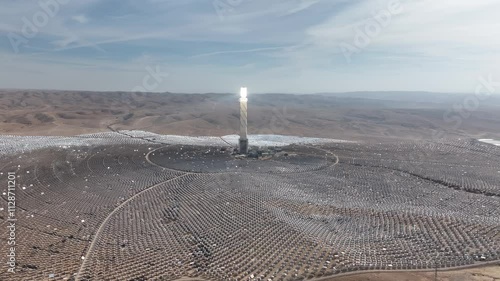 Aerial Drone view from Ashalim power station in Israel
Solar power tower absorbing sunlight from moving mirrors, Drone view, Israel 2024
 photo