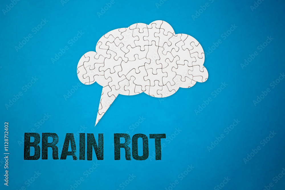 Brain shaped white jigsaw puzzle chat bubble with brain rot stamp letters written on blue background, social media addiction, mental health problems, 2024 year Brain shaped white jigsaw puzzle chat bubble with brain rot stamp letters written on blue background, social media addiction, mental health problems, 2024 year