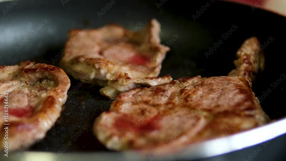 beef steak is fried in a frying pan, the butter melts during cooking. pork neck beef steak is fried in a frying pan, the butter melts during cooking. pork neck