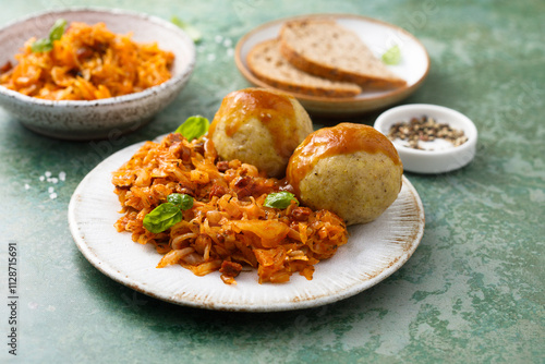 Fototapeta Naklejka Na Ścianę i Meble -  Stewed cabbage with dumplings and gravy