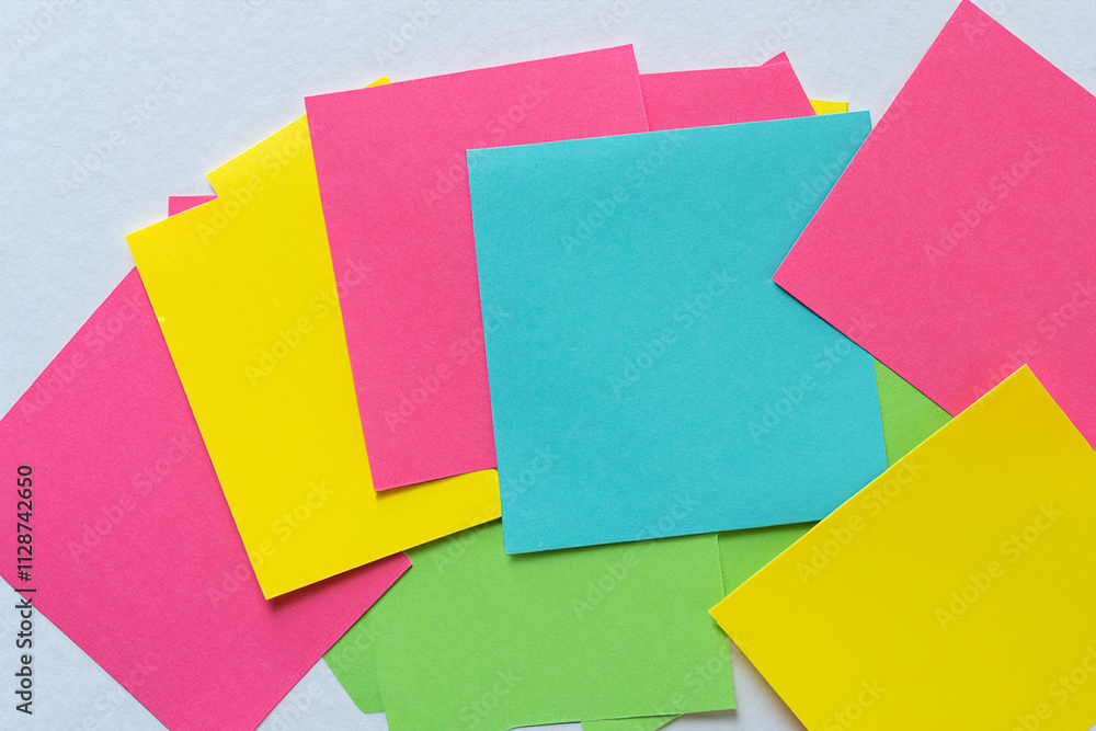 Colorful sticky notes on white background. A gray background with colored stickers. A square of gray paper lying on a background. Colored square paper lying on a lifestyle gray background. Colorful sticky notes on white background. A gray background with colored stickers. A square of gray paper lying on a background. Colored square paper lying on a lifestyle gray background.