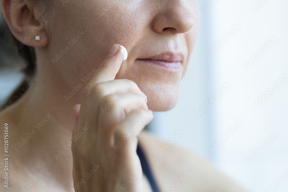 Woman applying cream on her face. Cosmetic cream for problem skin. Closeup. Woman applying cream on her face. Cosmetic cream for problem skin. Closeup.