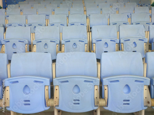 Empty Blue Stadium Seats Neatly Aligned in a Large Sports Arena Awaiting Upcoming Events. photo