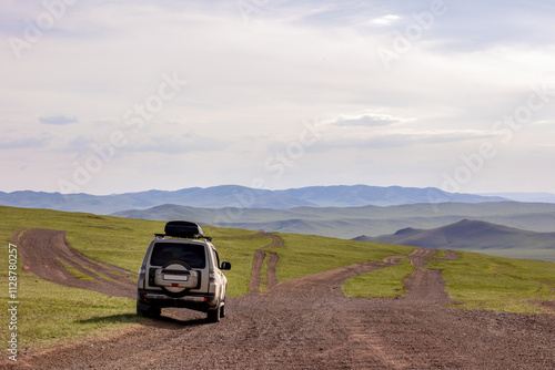 Japanese SUV on a dirt mongolian road in mountains