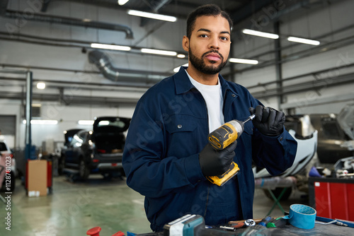 Skilled mechanic focused on his task in a bright and spacious auto repair shop photo