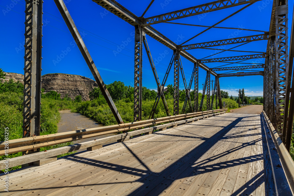 A bridge with a view of a forest and a mountain in the background A bridge with a view of a forest and a mountain in the background