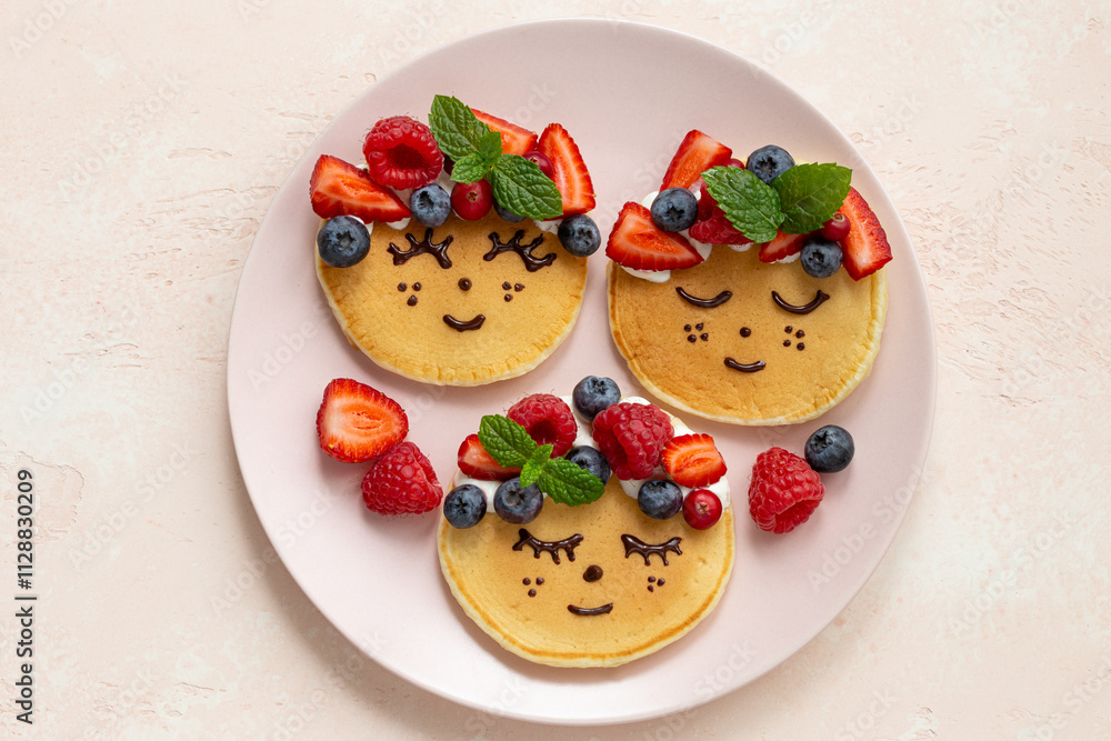 Funny kids food idea, cute smiling girl face pancakes Funny kids food idea, cute smiling girl face pancakes
