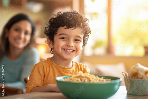 happy indian boy eating hakka noodles photo