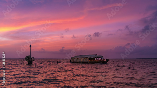 Canvas-taulu Kumarakom Backwater houseboat journey during coulourful sunset