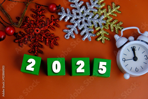 Calendar and new year concept. text of 2025 on colorful wooden blocks with Christmas theme. colorful lights. 