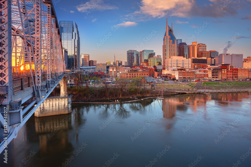 Fototapeta premium Nashville, Tennessee, USA. Cityscape image of Nashville, Tennessee, USA downtown skyline with reflection of the city the Cumberland River at spring sunrise.