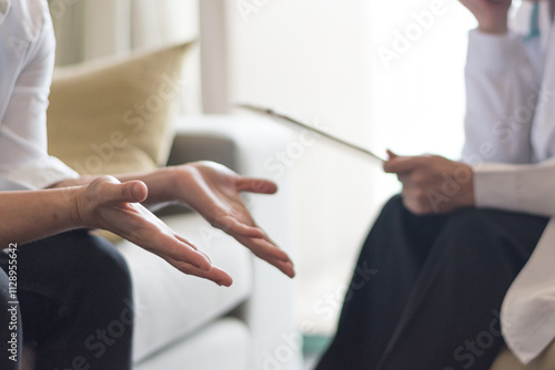 Psychologist conducting a psychotherapy session with a patient. The professional and empathetic interaction highlights mental health care, active listening, and guidance, set in a calm office