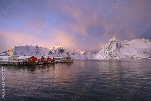 Soft and mysterious morning sunrise light over the  Hamnoy island and mountain chains along the Kirkefjord, Reine on the Lofoten Norway. (low key landscape photography) photo