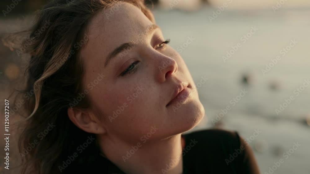 A closeup portrait of a woman gazing thoughtfully at the sunset, capturing a serene and reflective moment by the water. A closeup portrait of a woman gazing thoughtfully at the sunset, capturing a serene and reflective moment by the water.