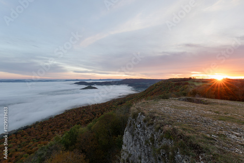 Sonnenaufgang und Nebel im Tal. Ausblick vom Breitenstein ( Ochsenwang ) Schwäbische Alb,  Landkreis Esslingen. Am Horizont die drei Kaiserberge - Hohenstaufen, Stuifen und Rechberg.  photo