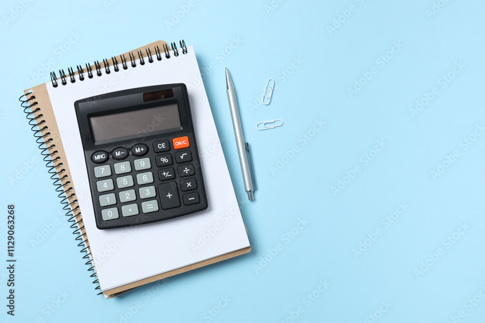 Bookkeepers work place concept. Top above overhead view photo of office accessories calculator, notebook on color backdrop with blank empty space Bookkeepers work place concept. Top above overhead view photo of office accessories calculator, notebook on color backdrop with blank empty space