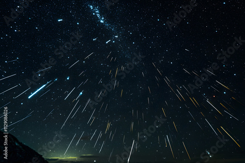 Perseids meteor Shower and the Milky Way silhouette in the foreground. Perseid Meteor Shower observation. Night sky nature summer landscape. Colorful shooting stars photo