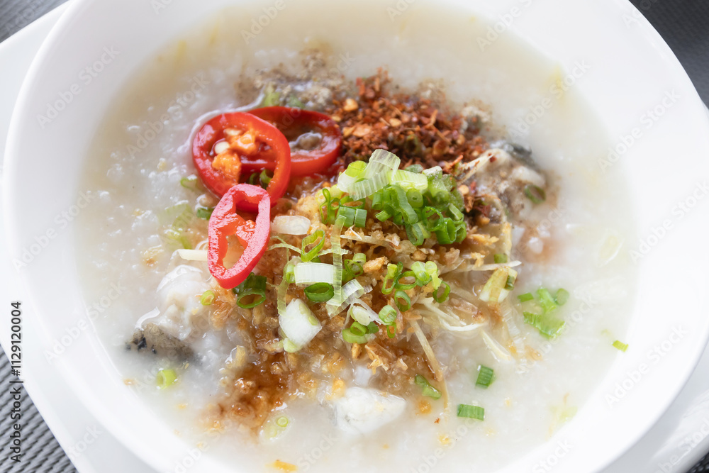 Rice congee with soft-boiled egg flavor with pickled chili vinegar and ground dried chilies Rice congee with soft-boiled egg flavor with pickled chili vinegar and ground dried chilies