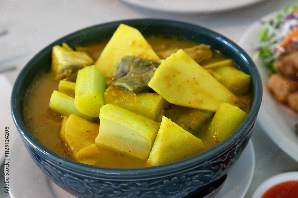 Yellow curry with fish, bamboo shoot and green taro (aaw dip) thai southern style food on table. Yellow curry with fish, bamboo shoot and green taro (aaw dip) thai southern style food on table.