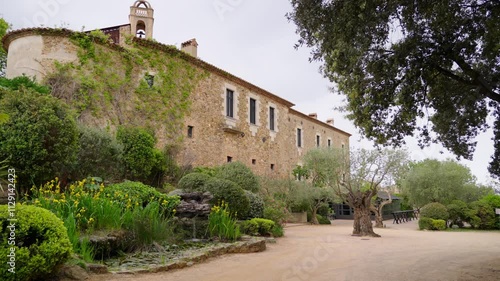 Castell d Emporda hotel vintage stone facade in green garden