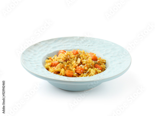 Delicious pumpkin risotto in bowl isolated on white