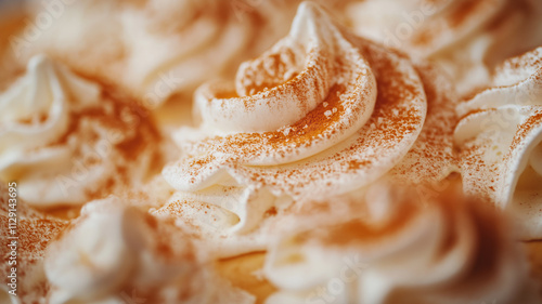 Close up of whipped cream swirls with cinnamon. Sweet dessert food photography. photo