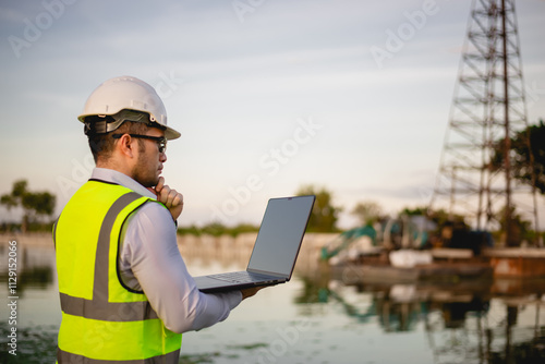 A foreman is checking the completion of a building construction project at an industrial factory.