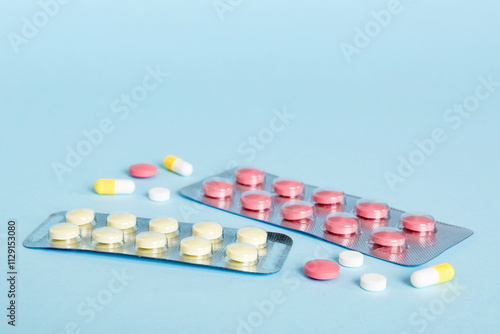 Blister package with Vitamin on color background. Medicine pills on a light background. Medicines and prescription pills flat lay background. pink medical tablets in blister