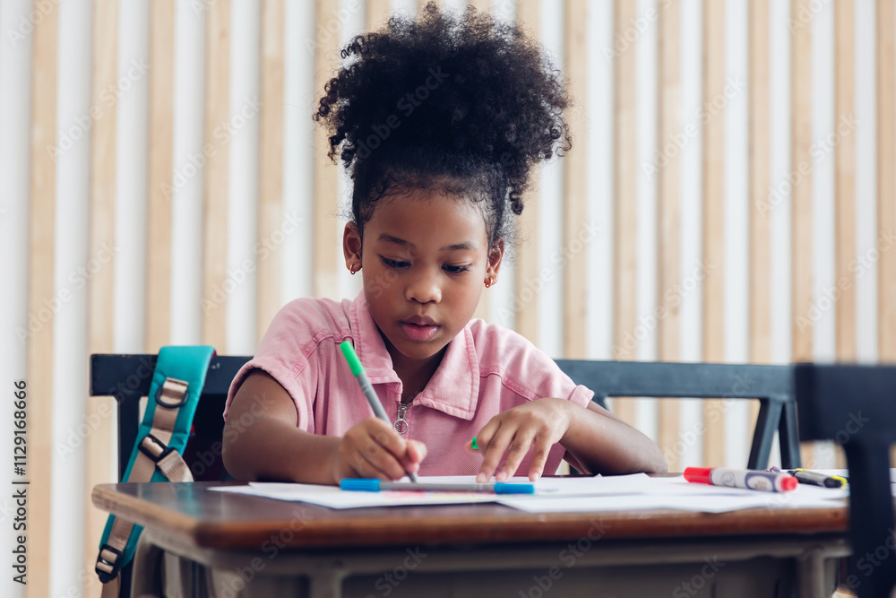 Fototapeta premium Girl is study in the Classroom. Back to school! Cute industrious children are sitting at desks indoors. Kids are learning in class.