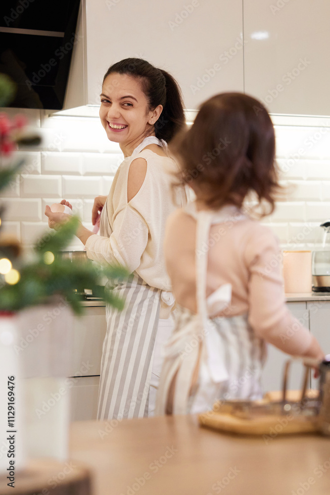 cute little child girl in apron baking cookies in the kitchen, focus on mom, Christmas Traditions cute little child girl in apron baking cookies in the kitchen, focus on mom, Christmas Traditions