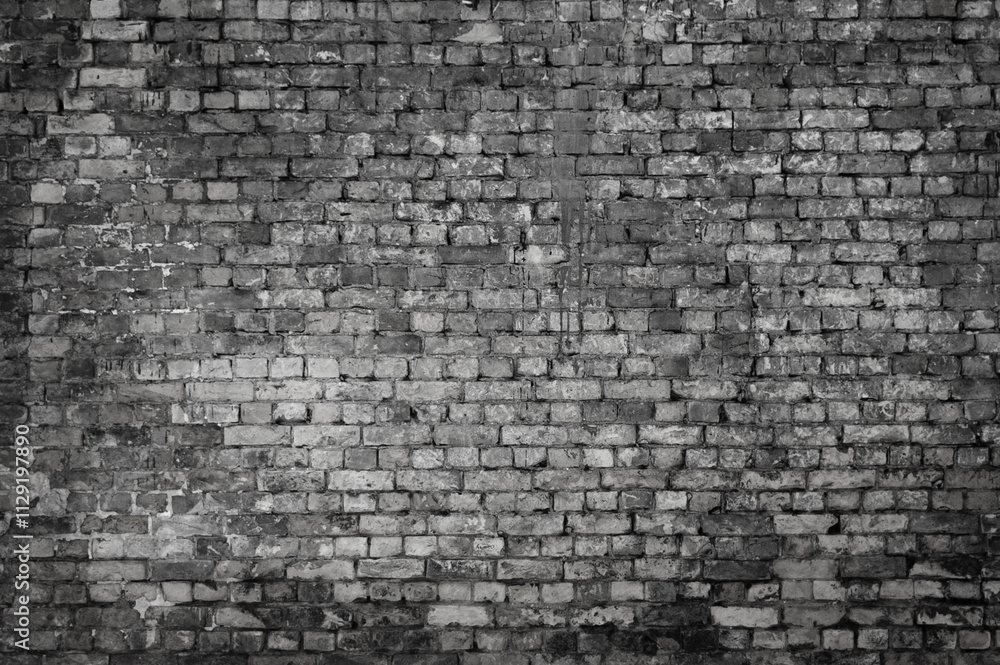 The photo shows a close-up of a grey brick wall The photo shows a close-up of a grey brick wall