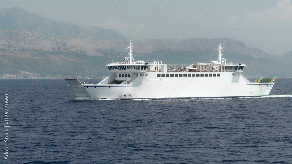 A ferry transports cars and passengers across the Adriatic Sea between the port city of Split and the island of Brac. Transportation and maritime connection between mainland Croatia and the islands. A ferry transports cars and passengers across the Adriatic Sea between the port city of Split and the island of Brac. Transportation and maritime connection between mainland Croatia and the islands.
