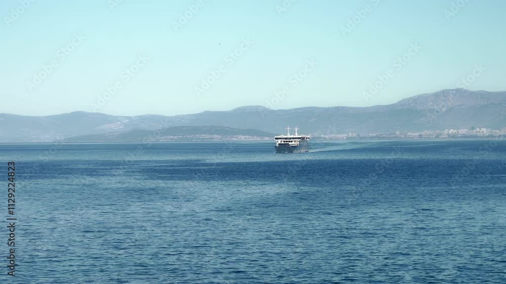 A ferry transports cars and passengers across the Adriatic Sea between the port city of Split and the island of Brac. Transportation and maritime connection between mainland Croatia and the islands. A ferry transports cars and passengers across the Adriatic Sea between the port city of Split and the island of Brac. Transportation and maritime connection between mainland Croatia and the islands.