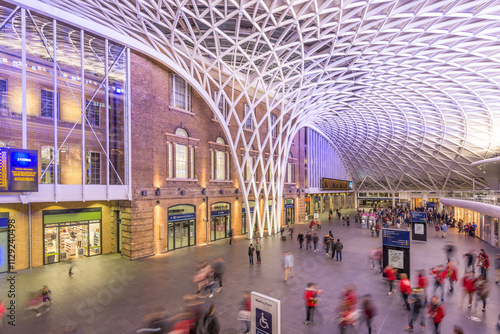 Unique architectural design of a busy train station atrium in Central London during evening rush hour