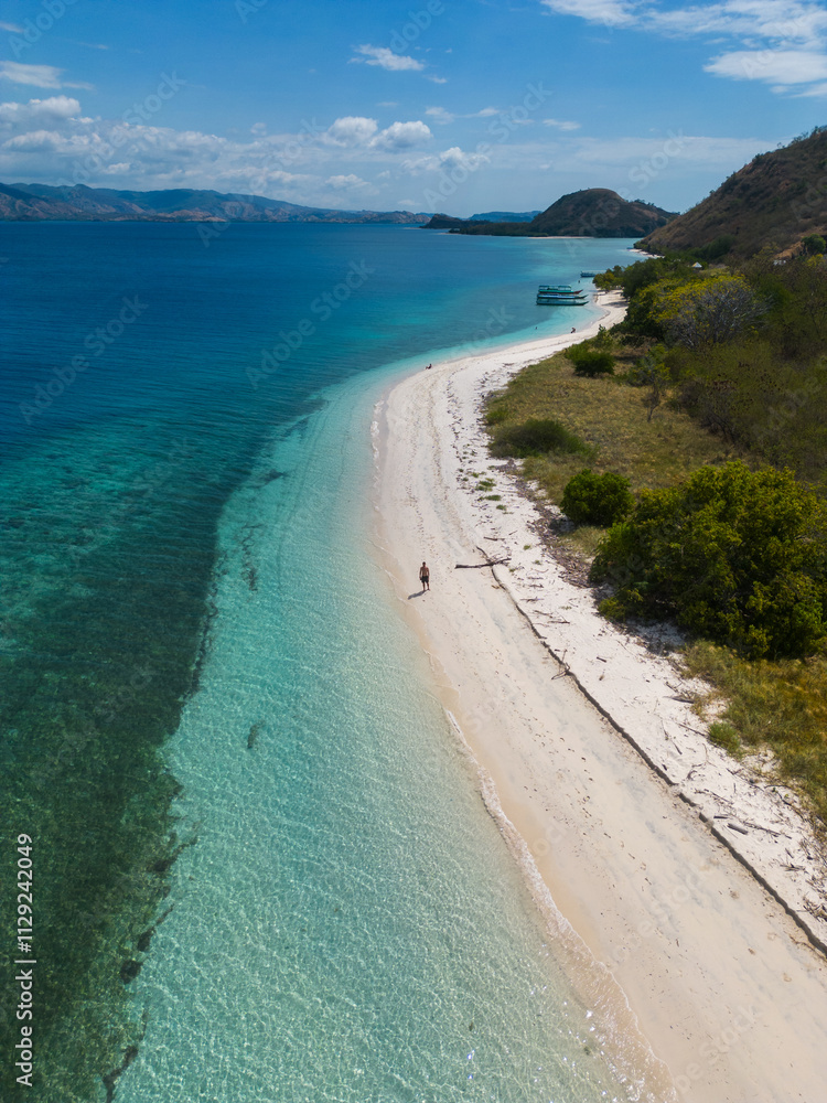 A serene beach with clear blue waters and lush greenery in a tropical paradise. A serene beach with clear blue waters and lush greenery in a tropical paradise.