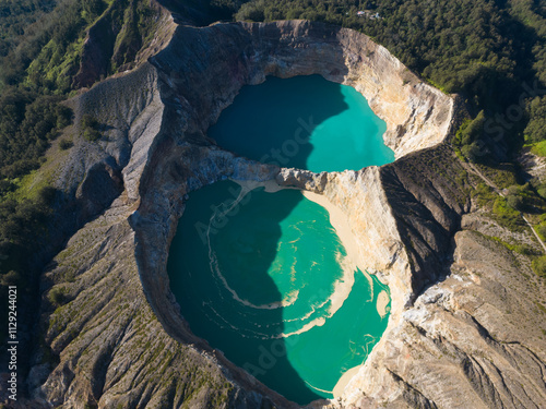 фотографія Aerial view of vibrant turquoise crater lakes surrounded by lush terrain
