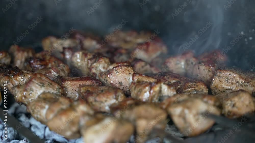 Close up grilling cooking skewers with marinated shashlik. Juicy slices of meat spiced on fire. Barbecue picnic BBQ. Close up grilling cooking skewers with marinated shashlik. Juicy slices of meat spiced on fire. Barbecue picnic BBQ.
