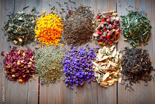 Vibrant display of natural herbs and spices arranged artfully on a rustic wooden surface photo