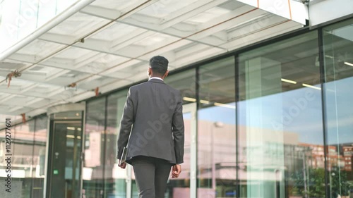 Wallpaper Mural Businessman walking towards office building Torontodigital.ca