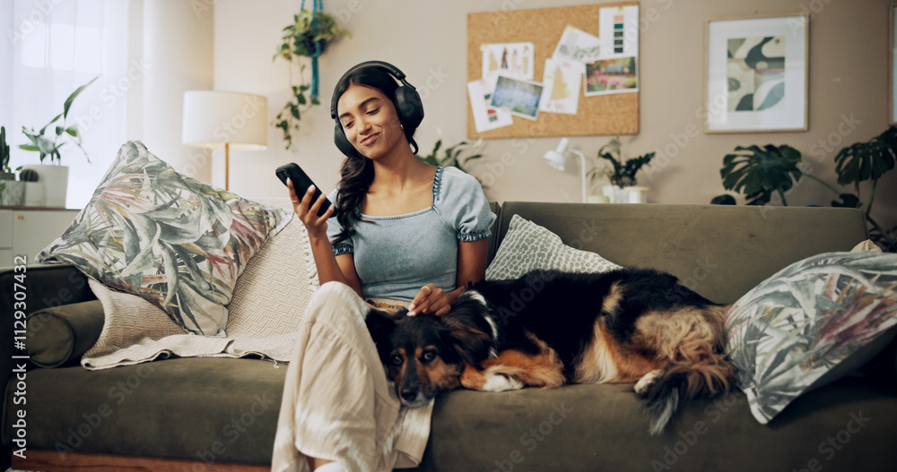 © peopleimages.com - Woman, headphones and dog for music in home, surfing audio website and online for playlist search. Female person, hearing podcast and app for communication on couch, pet care and internet for sound