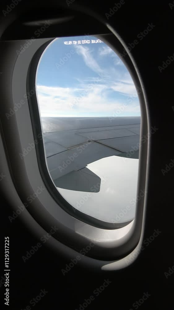 Vertical Shot: Looking out the window of airplane Vertical Shot: Looking out the window of airplane
